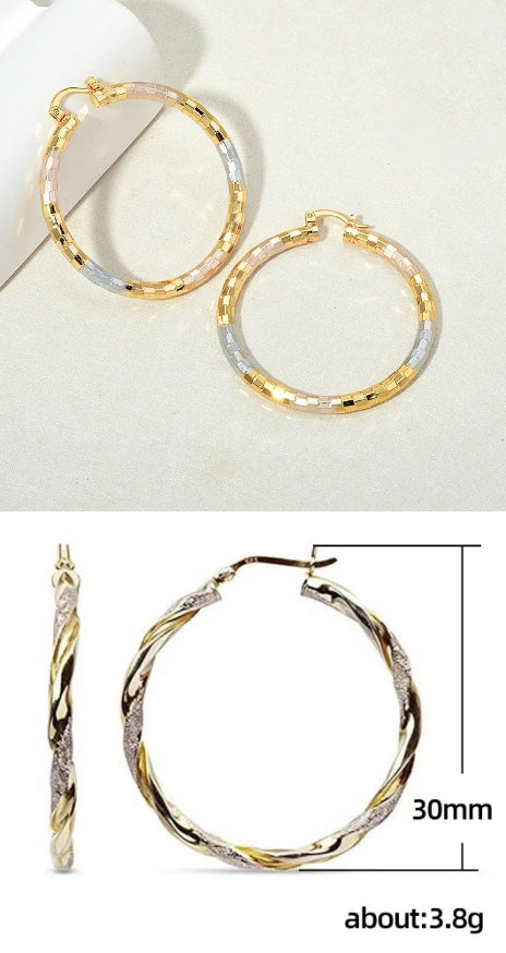 Gold hoop earrings with a measurement label on a white background