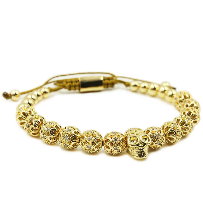 Gold bracelet with intricate design on a white background