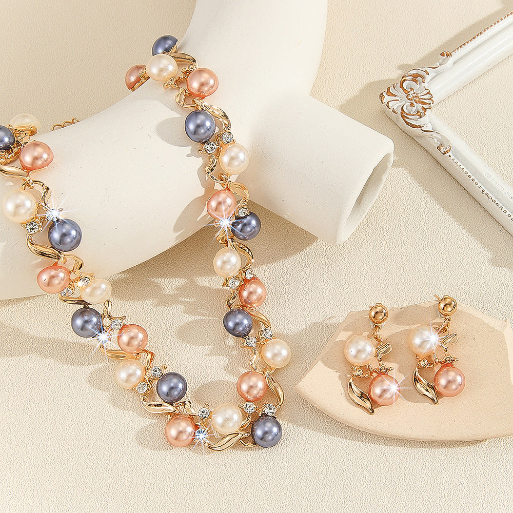 Pearl necklace and earrings on a beige background