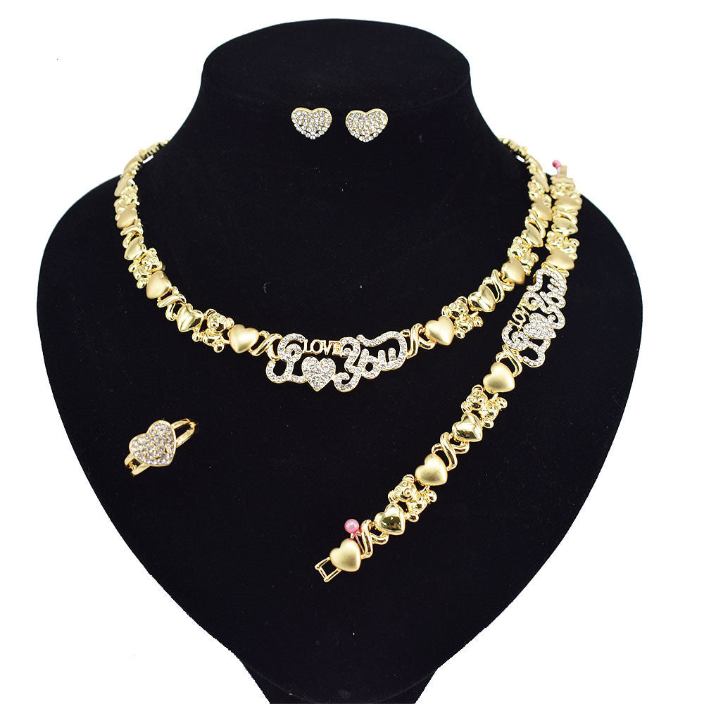 Gold necklace, bracelet, and earrings on a black mannequin bust.