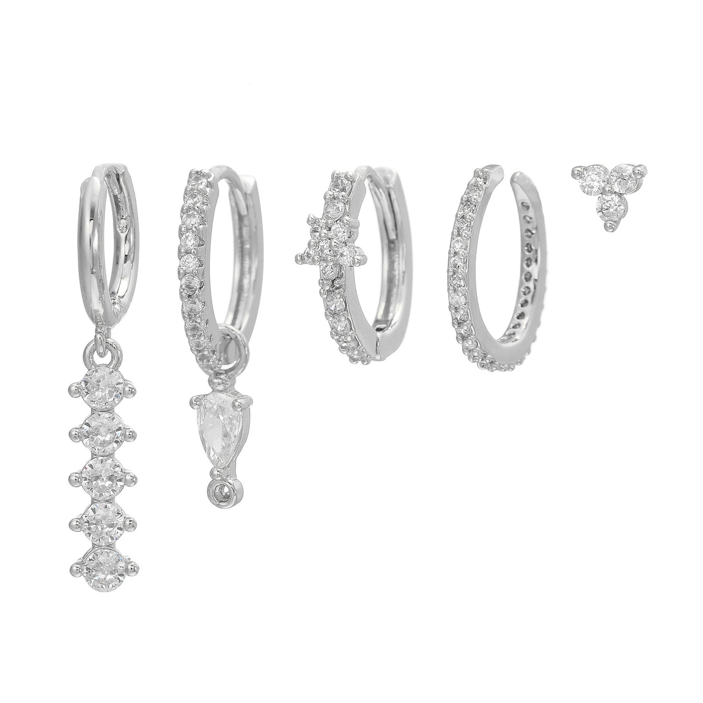 Set of silver hoop earrings with additional diamond-studded earrings on a white background