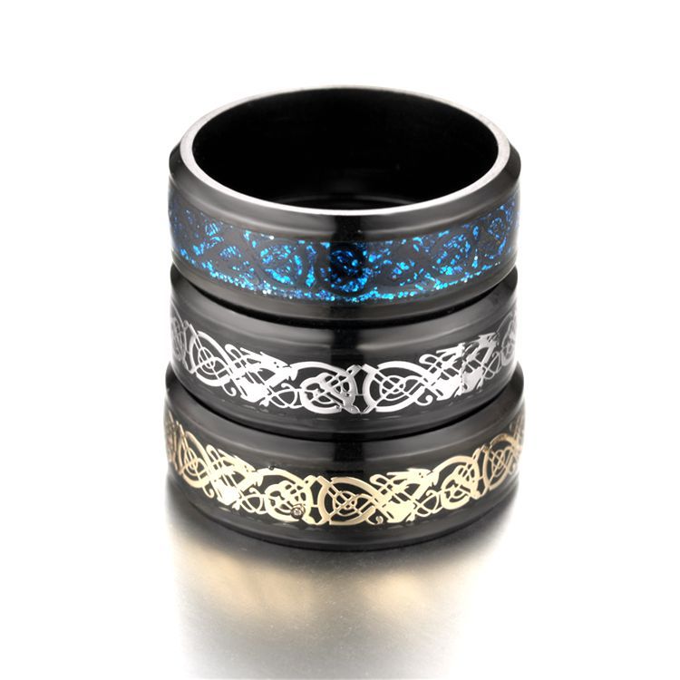 Three black rings with blue, white, and gold Celtic knot designs on a white background
