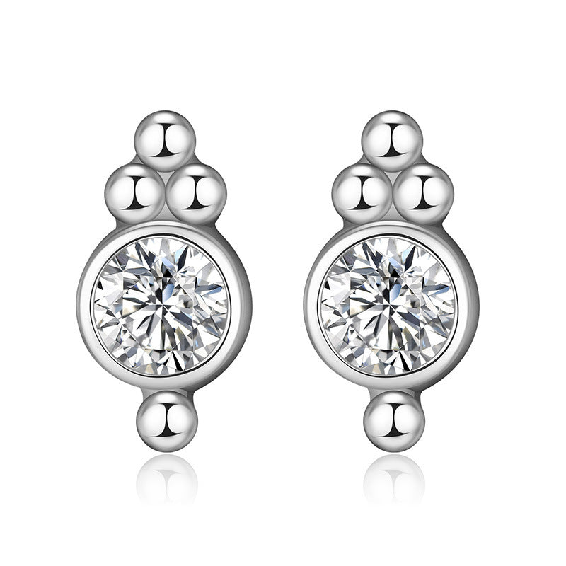 Silver earrings with round gemstones on a white background