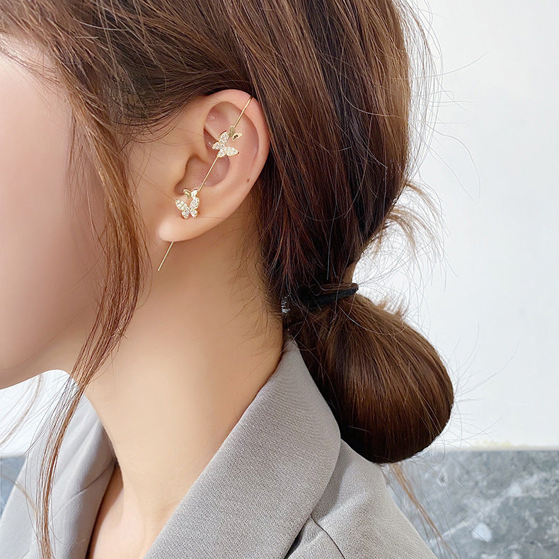 Close-up of a person wearing floral earrings with a blurred background
