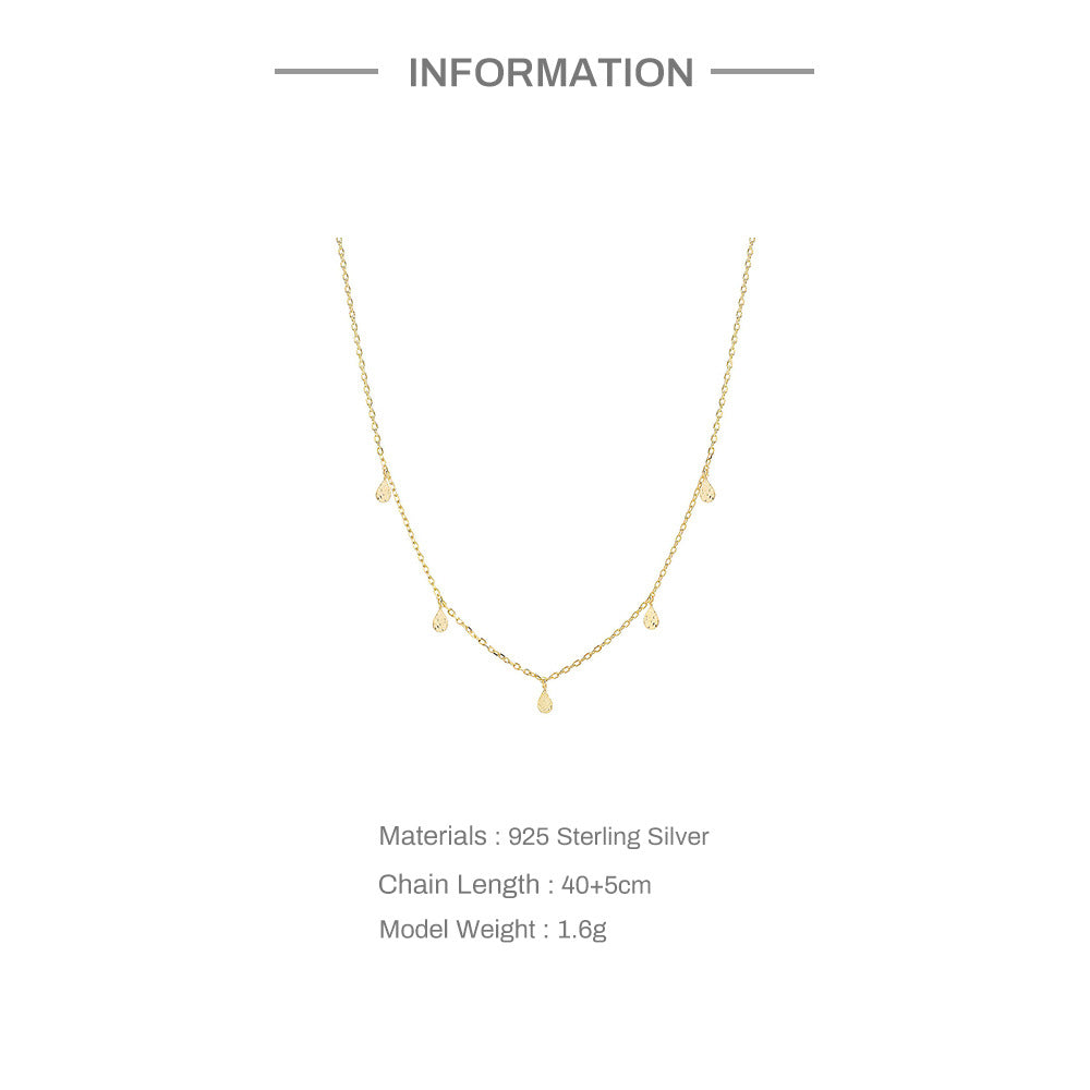 Gold necklace on a white background with product details.