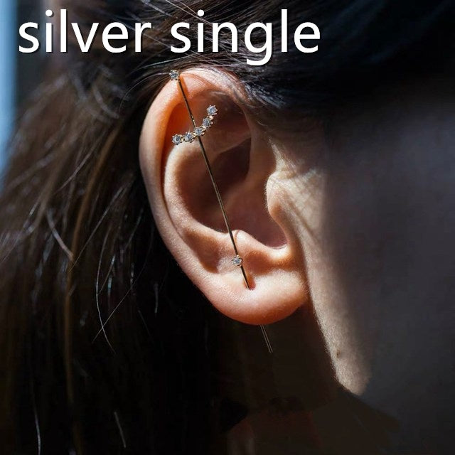 Close-up of an ear with a silver earring, text 'silver single' above.