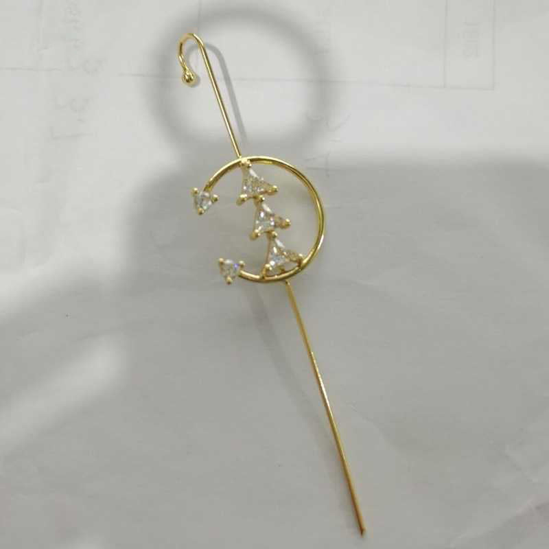 Gold hairpin with star and moon design on a white background