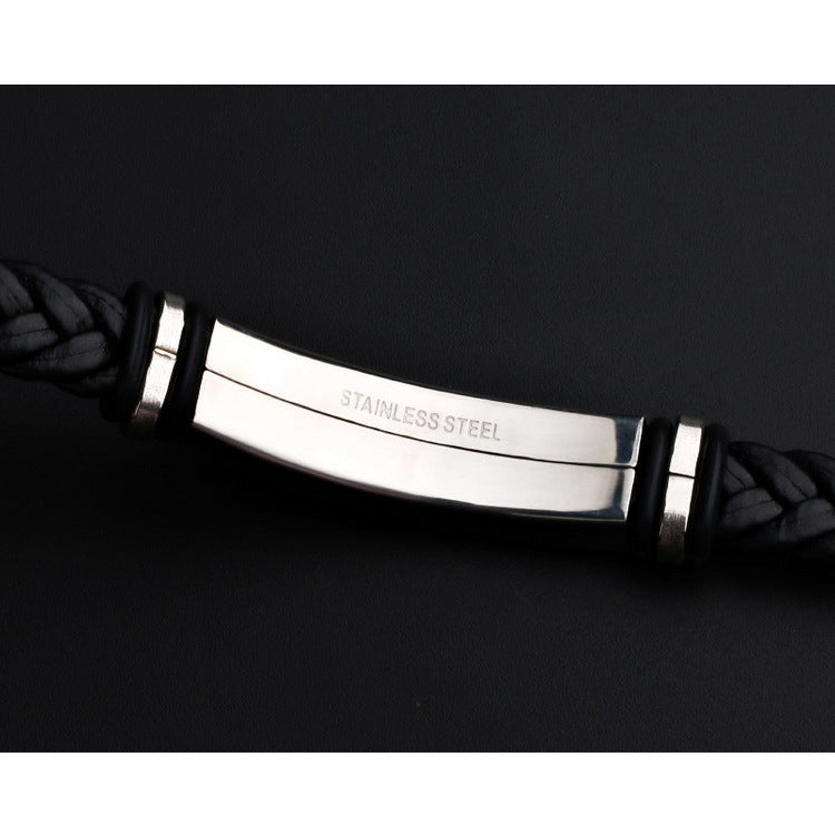 Black braided leather bracelet with a stainless steel clasp on a dark background