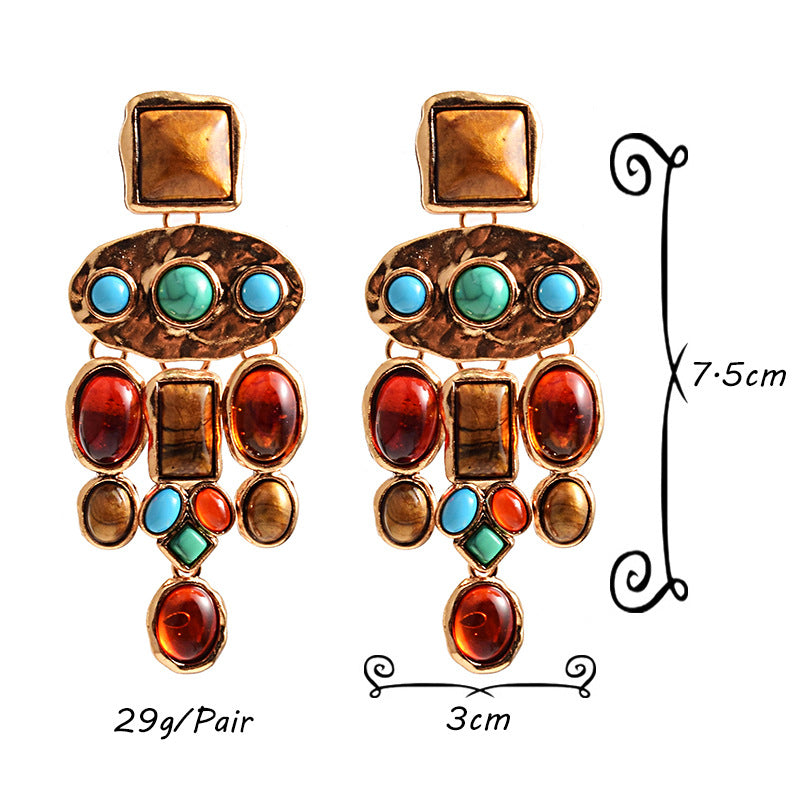 Pair of earrings with colorful gemstones and measurements on a white background
