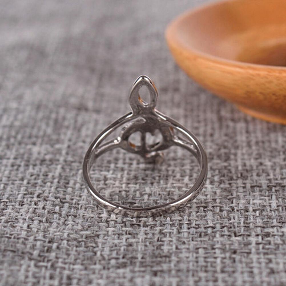 Silver ring with a unique design on a textured fabric background