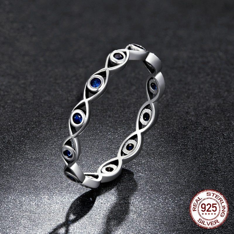 Silver ring with blue gemstones on a dark background, featuring 'Recal' branding.