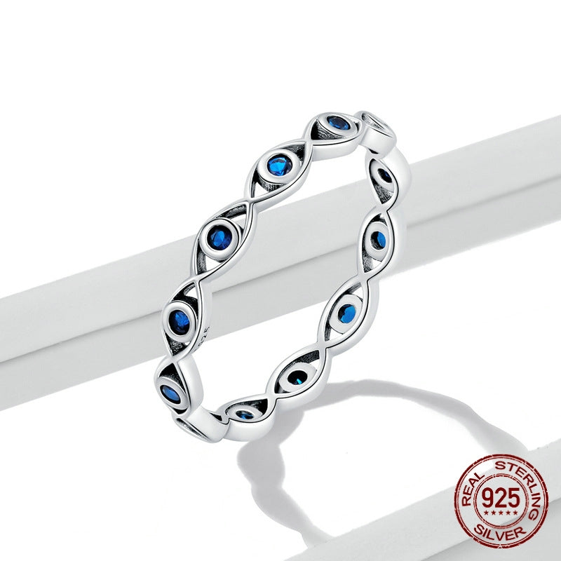 Silver ring with blue gemstones on a white background