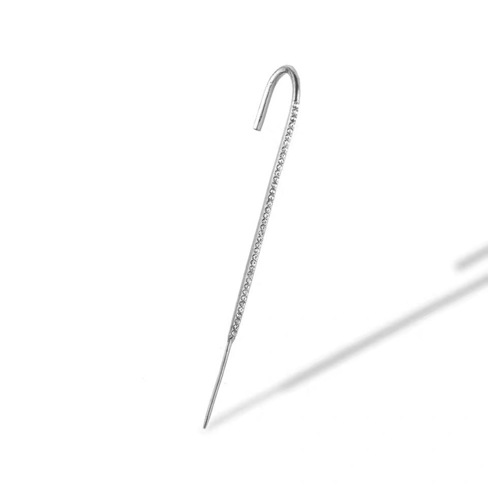 Silver ear cuff on a white background