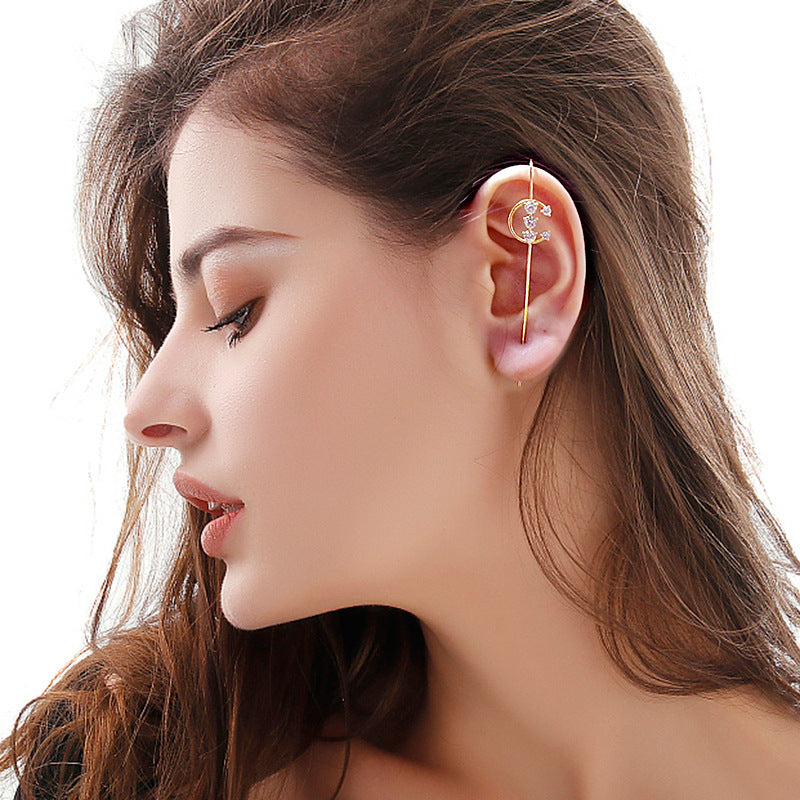 Close-up of a woman wearing an ear cuff with a delicate design on a white background