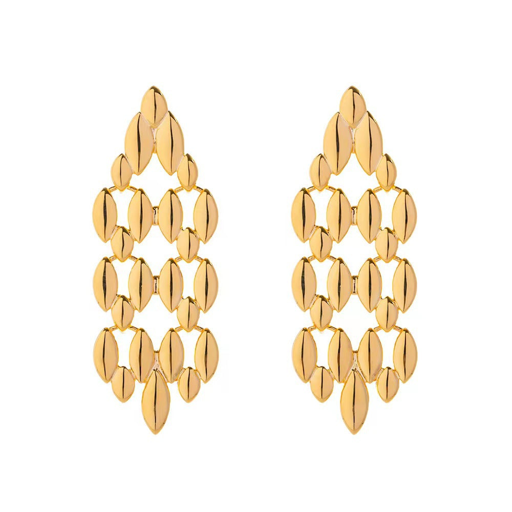 Gold chandelier earrings on a white background