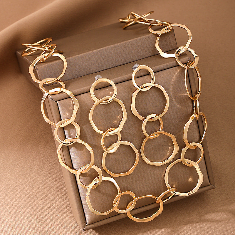 Gold chain necklace on a brown box with a brown background