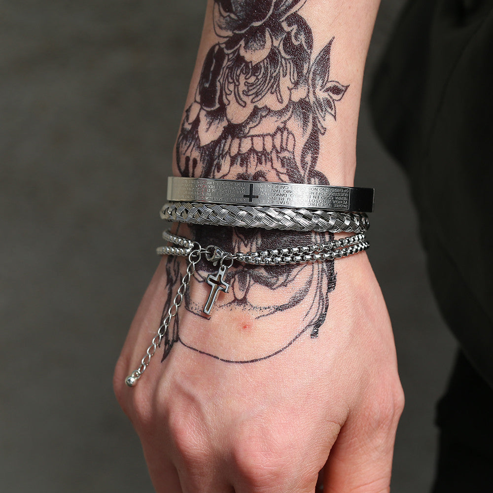 Hand wearing multiple bracelets with tattoos on the arm