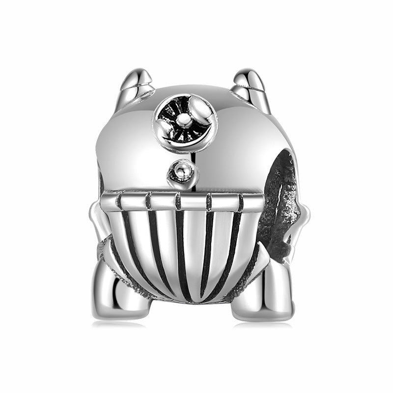 Silver beetle charm with clear gemstones on a white background
