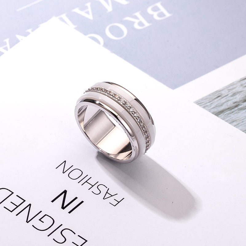 Silver ring with embedded stones on a magazine page