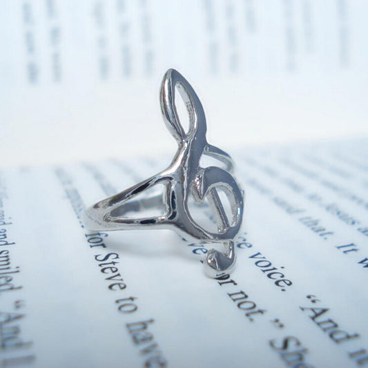 Silver ring with a unique design on an open book
