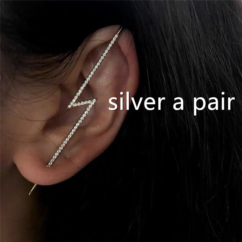 Silver ear cuff worn on an ear with text 'silver a pair' on a dark background