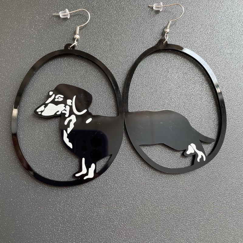 Black hoop earrings with white horse designs on a gray background