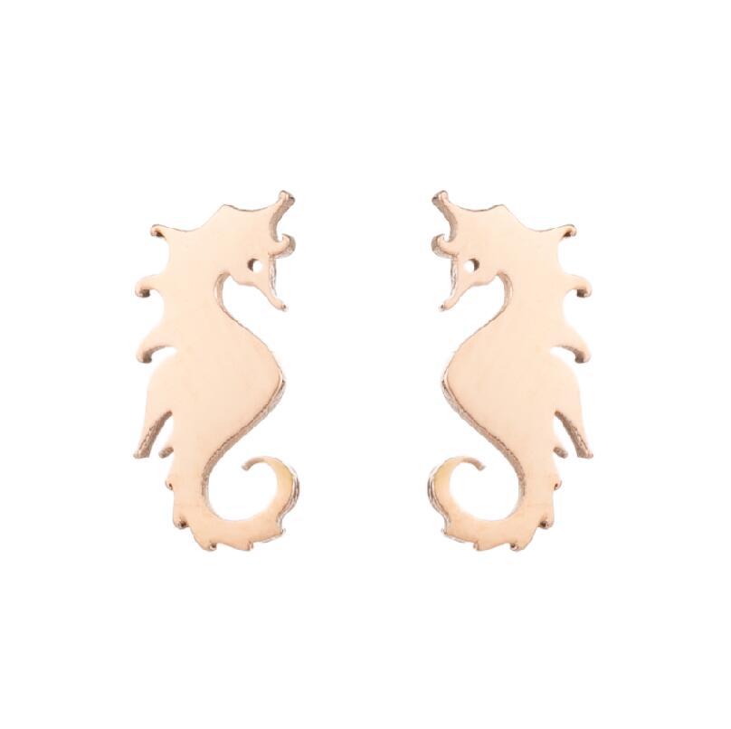 Rose gold seahorse-shaped earrings on a white background