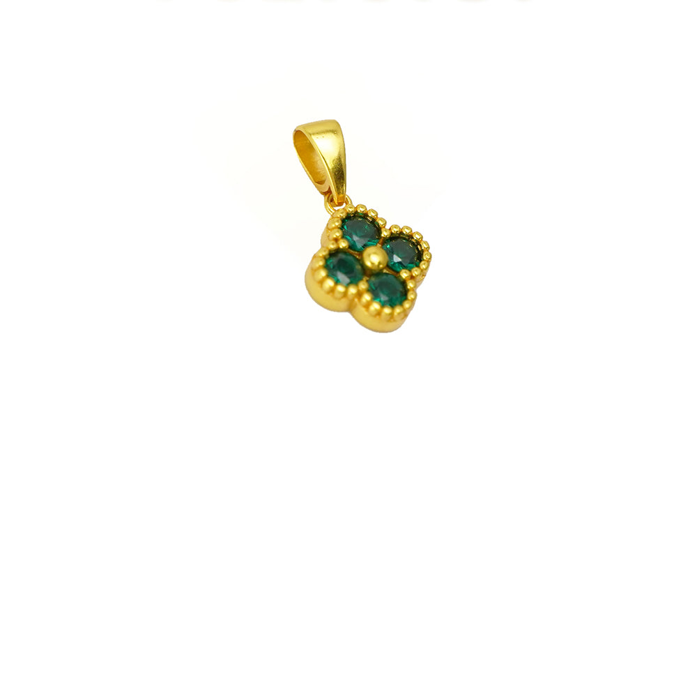 Gold pendant with green gemstones on a white background