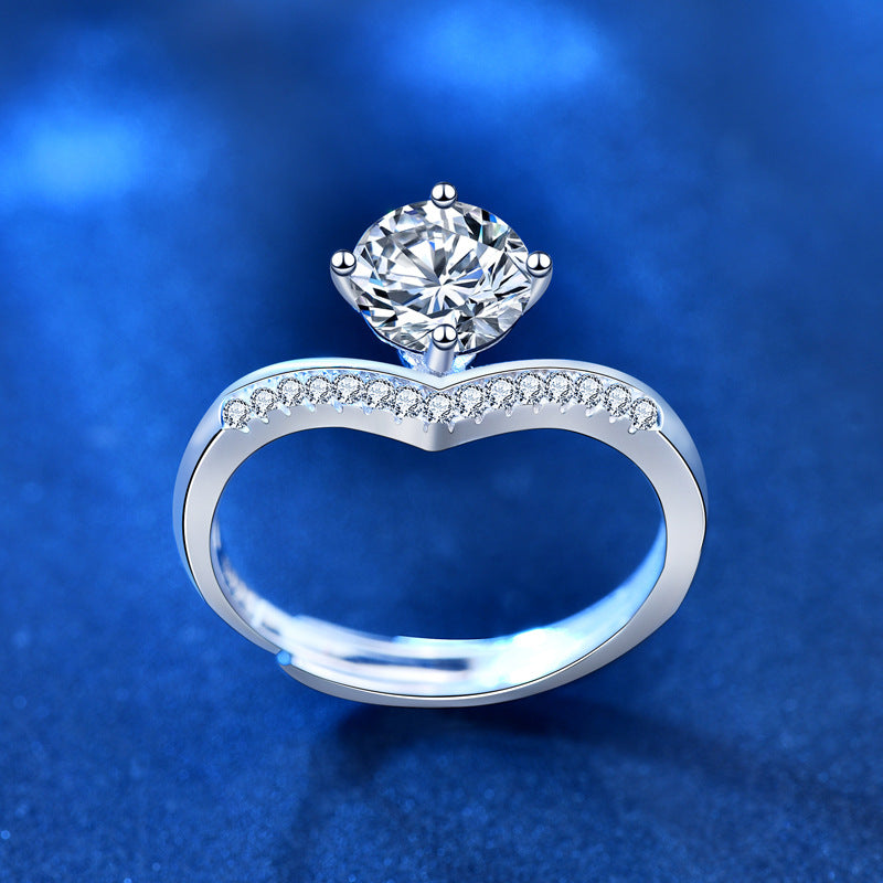 Silver ring with a large diamond on a blue background