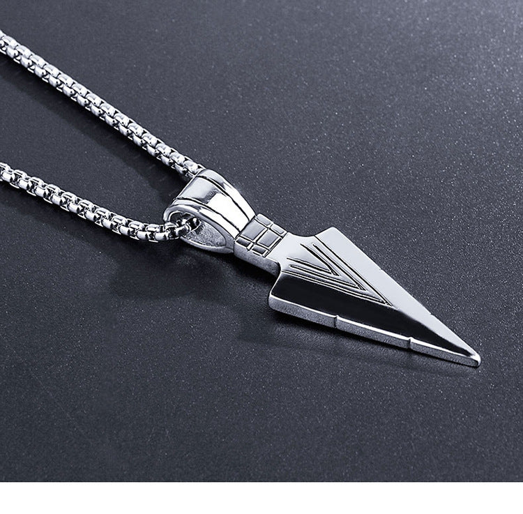 Silver arrowhead pendant necklace on a dark background