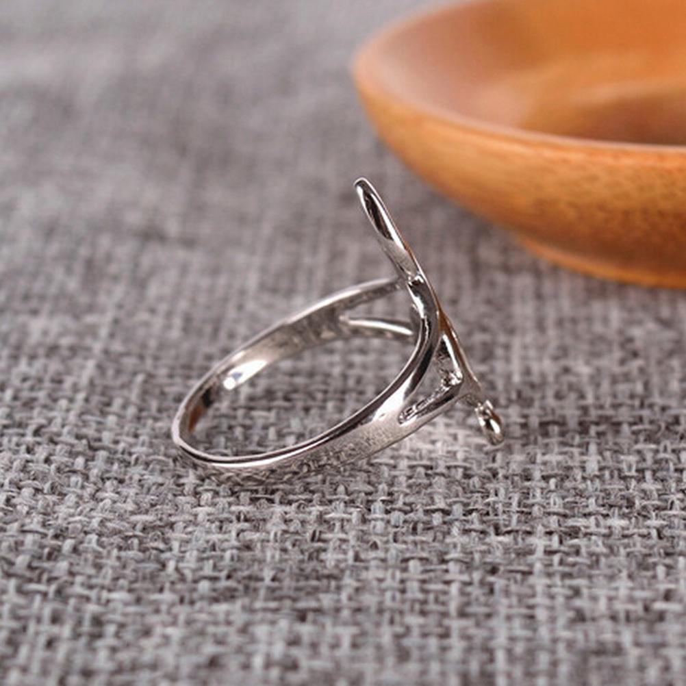 Silver ring with a unique design on a textured surface