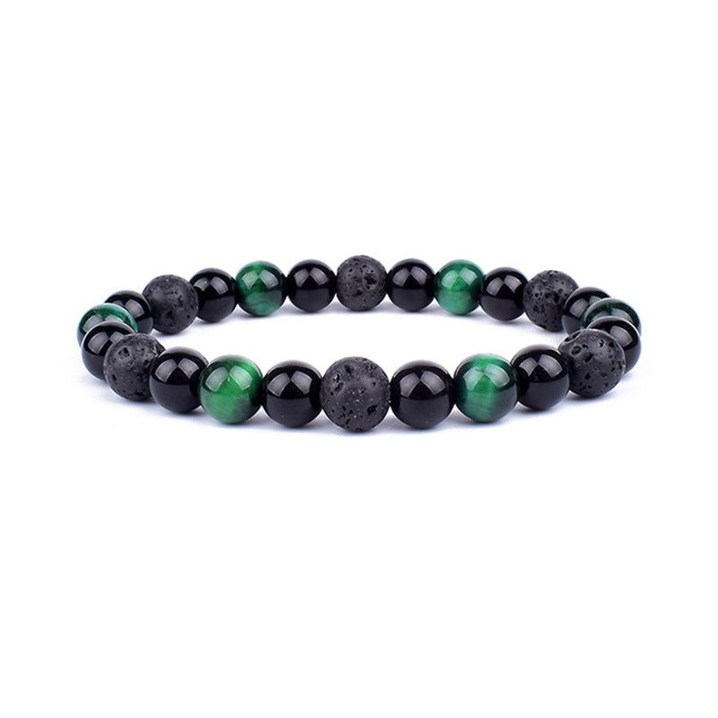 Beaded bracelet with black and green stones on a white background