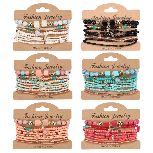 Set of six packages of fashion jewelry bracelets with different color combinations on a beige background.