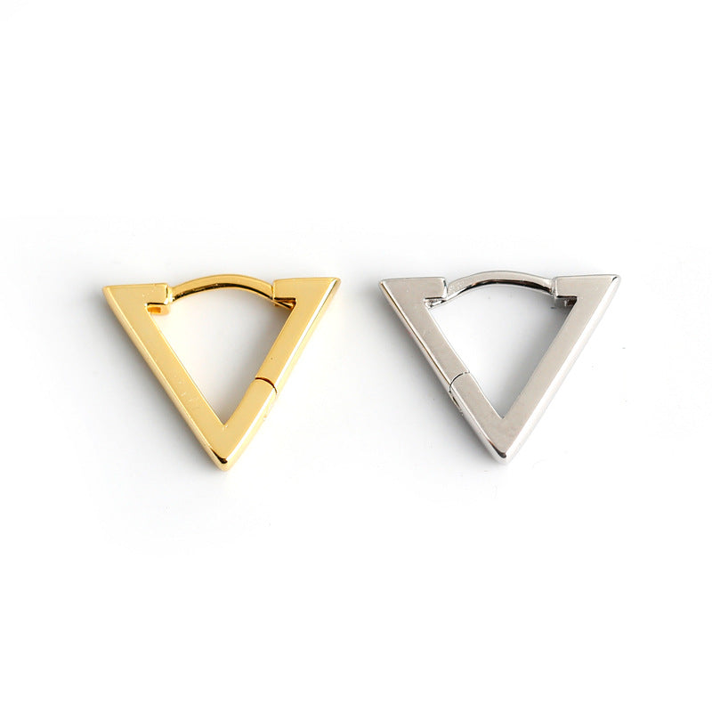 Two triangular earrings, one gold and one silver, on a white background