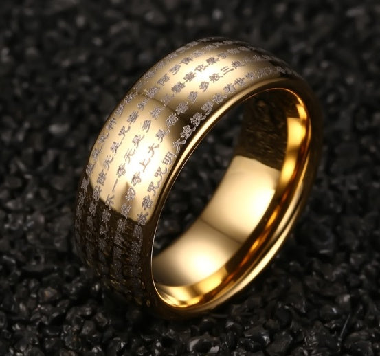 Gold ring with engraved text on a textured black background