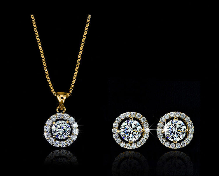 Jewelry set with round diamond earrings and a necklace on a black background