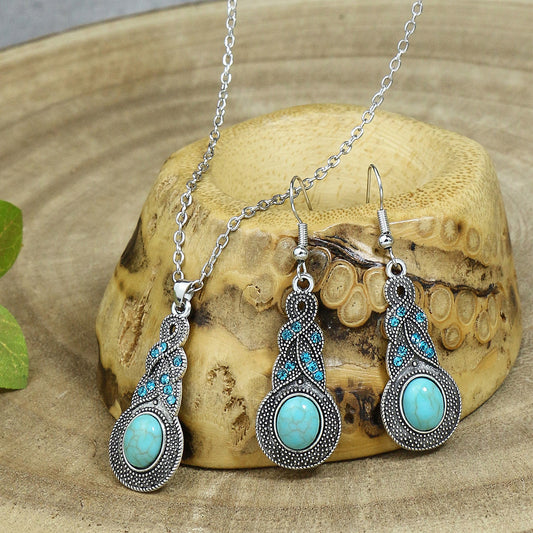 Turquoise jewelry set with necklace and earrings on a wooden surface