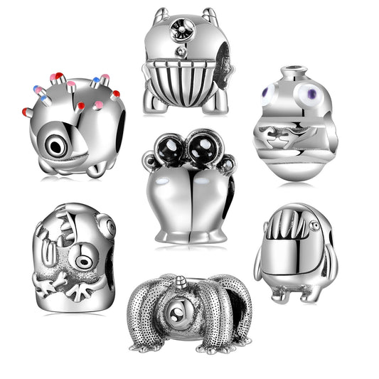 Set of silver charm beads with various designs on a white background