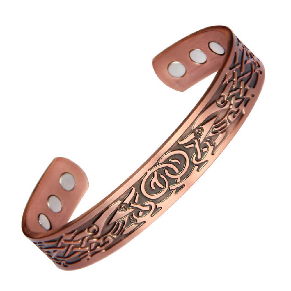 Copper bracelet with intricate designs on a white background