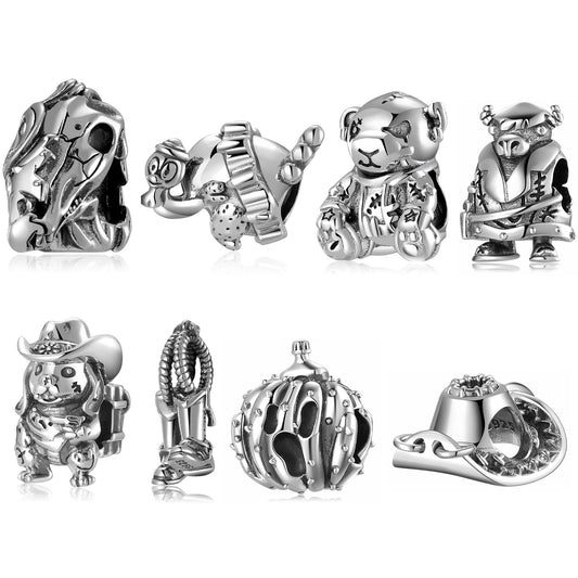 Collection of silver-themed charms on a white background