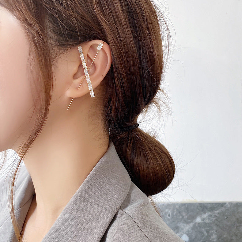Earring worn by a person with a neutral background