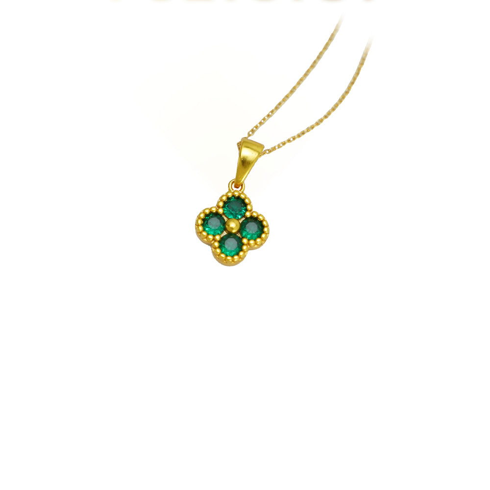 Gold necklace with a green gemstone pendant on a white background