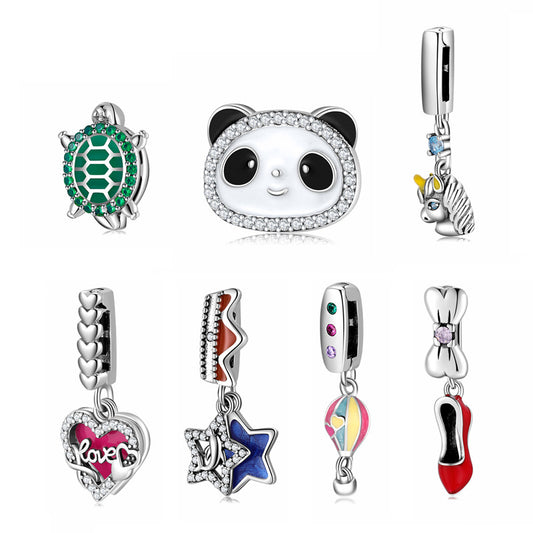 Collection of various charm beads with different designs on a white background