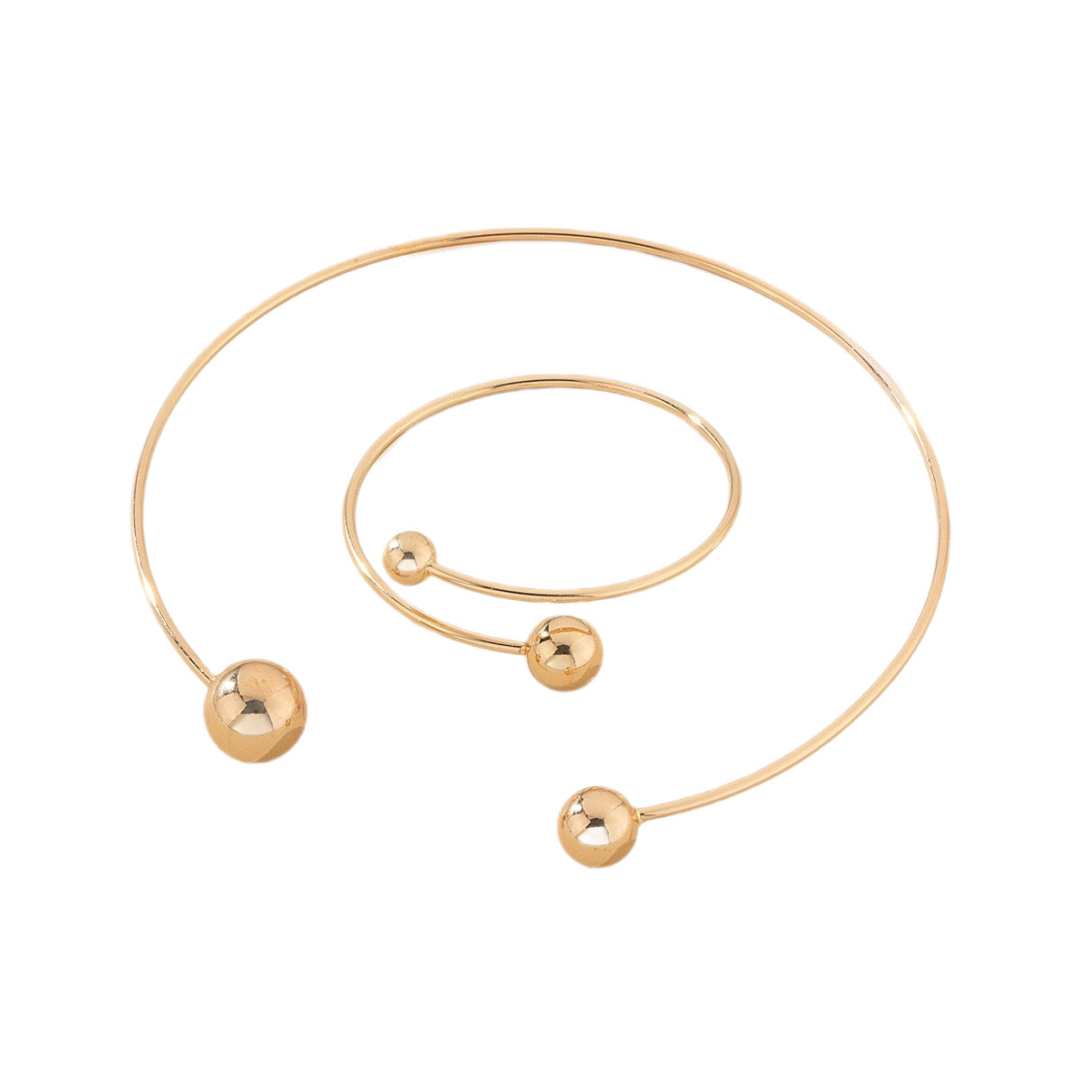 Gold bracelet with three spherical charms on a white background
