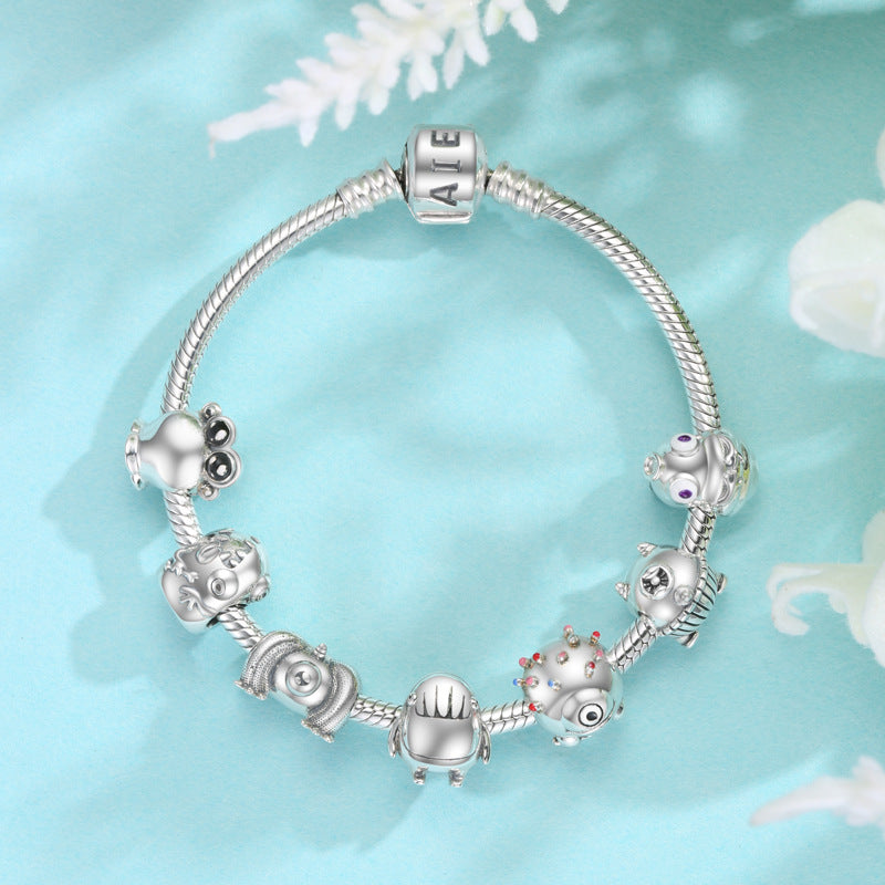 Silver bracelet with charms on a light blue background