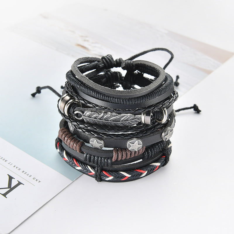 Stack of leather bracelets with various designs on a light surface