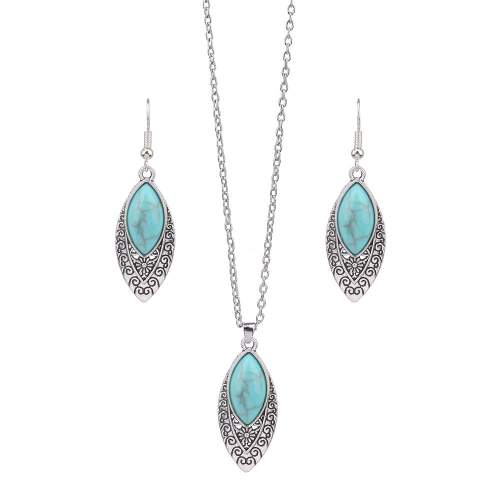Jewelry set with turquoise stones and silver accents on a white background