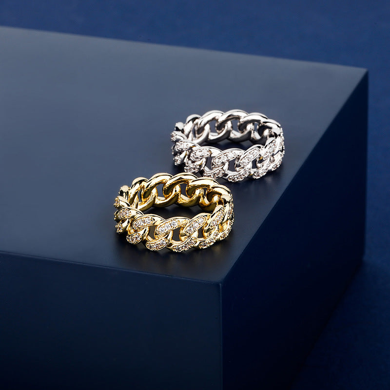 Two gold chain-style rings on a dark blue surface