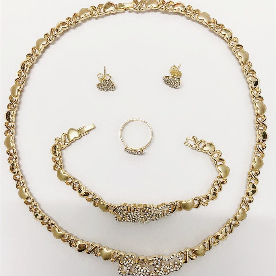 Gold jewelry set including necklace, bracelet, ring, and earrings on a white background