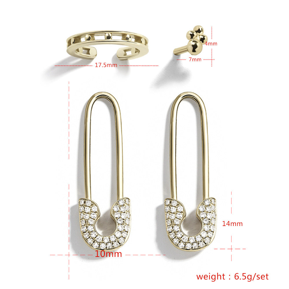 Gold safety pin earrings with clear gemstones, shown with measurements on a white background.